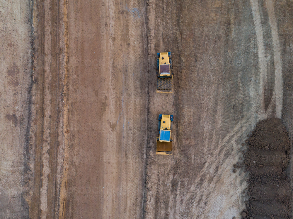 Aerial view of two heavy machinery vehicles for earthworks on construction site for Singleton Bypass - Australian Stock Image
