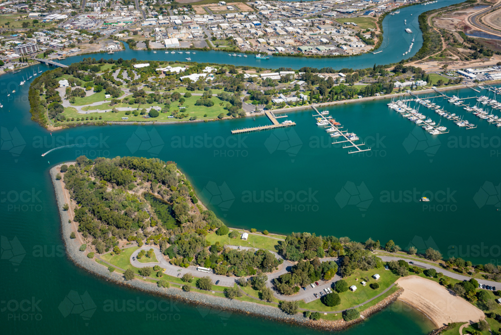 Aerial view of two islands with marina and urban coastline at sunset - Australian Stock Image