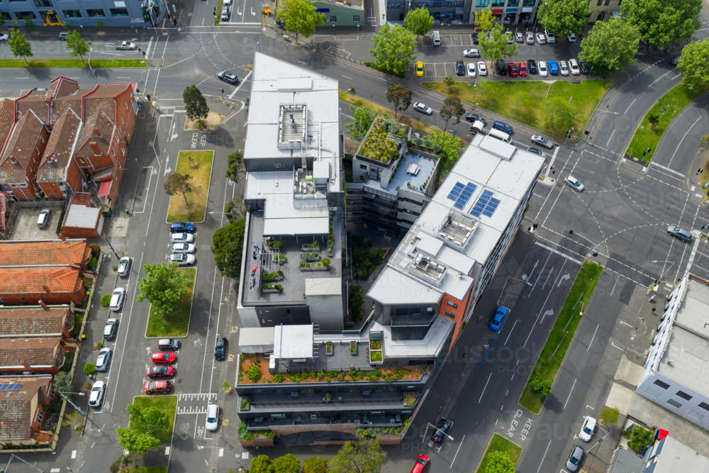Aerial view of V shaped high rise apartments building surrounded by busy city streets - Australian Stock Image