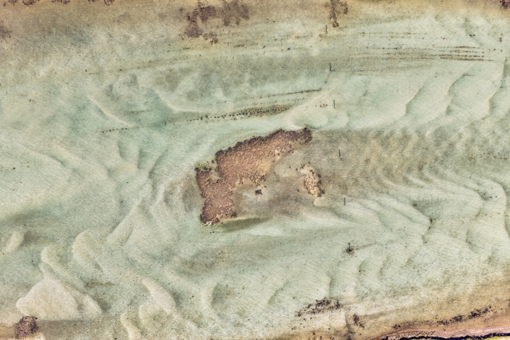 Aerial view of Wallis Lake at low tide, revealing intricate sand patterns - Australian Stock Image
