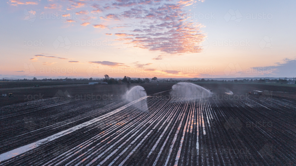Aerial view of water irrigation on farm at dawn in Queensland - Australian Stock Image