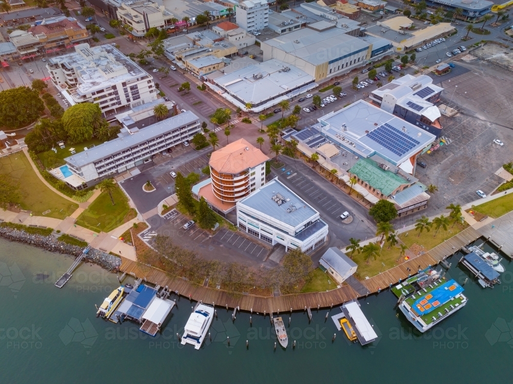 Image of Aerial view of waterfront buildings with boats and jetties