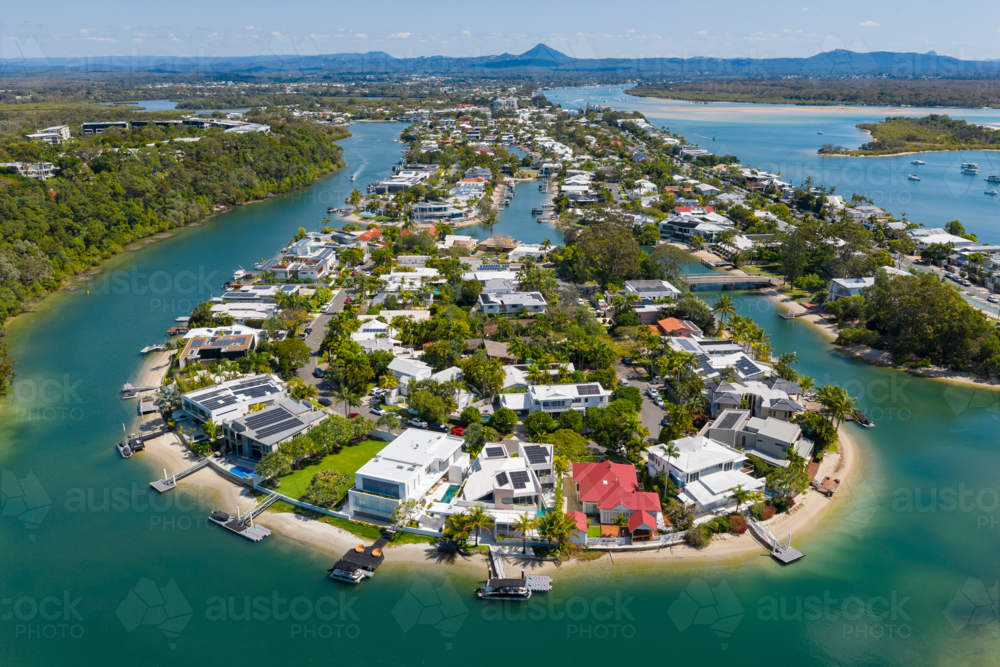 Aerial view of waterfront properties and jetties along coastal canals - Australian Stock Image