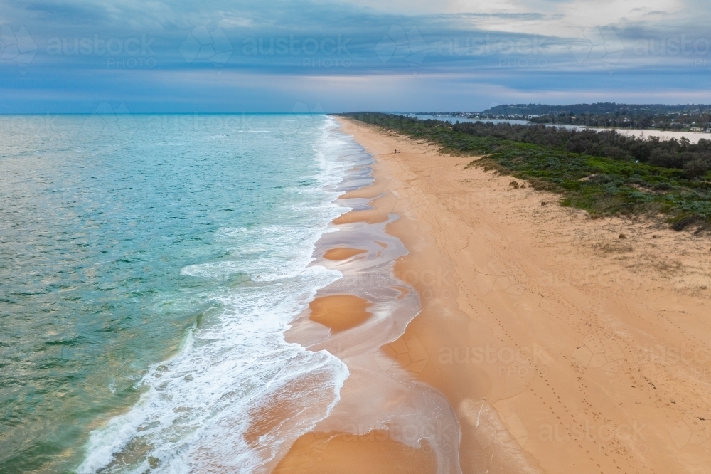 image-of-aerial-view-of-wave-crashing-and-leaving-patterns-on-a-wide