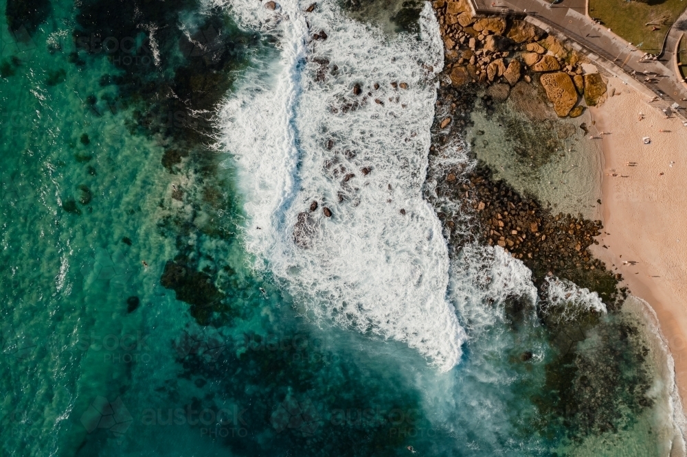 Aerial view of waves crashing into the Bogey Hole at Bronte Beach - Australian Stock Image