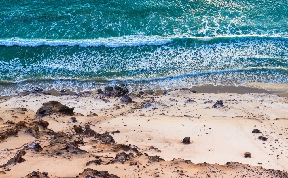 Aerial view of waves crashing on beach - Australian Stock Image