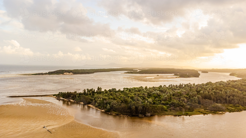 aerial view of winding river with sandy banks at sunset - Australian Stock Image