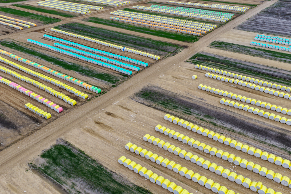 Aerial view of wrapped round cotton modules with various coloured wrap neatly lined up in rows. - Australian Stock Image