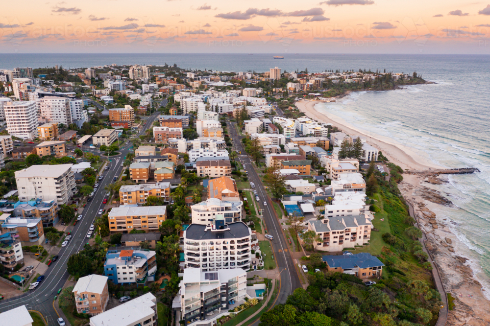 Image of Aerial view over a coastal city with highrise buildings at ...
