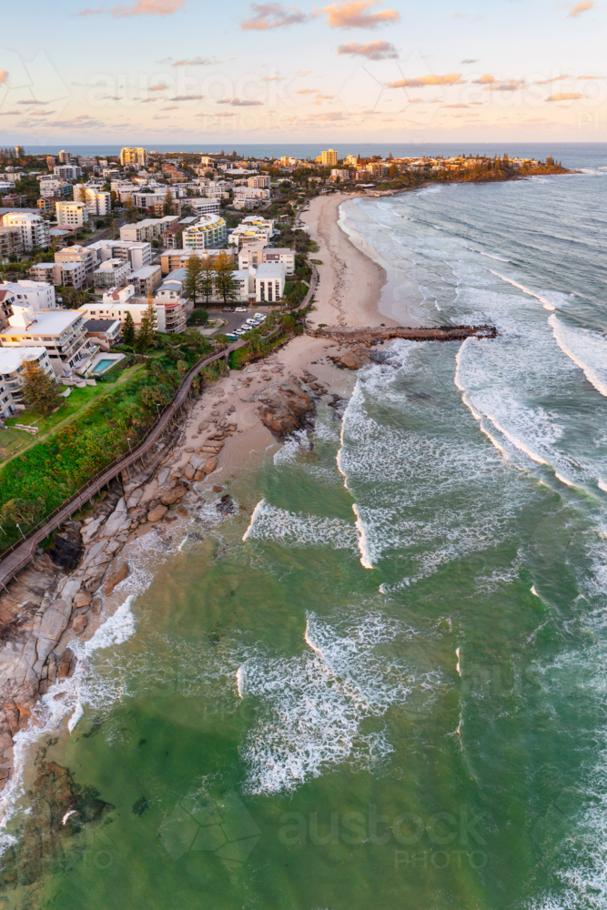 Image of Aerial view over a coastal city with highrise buildings at ...