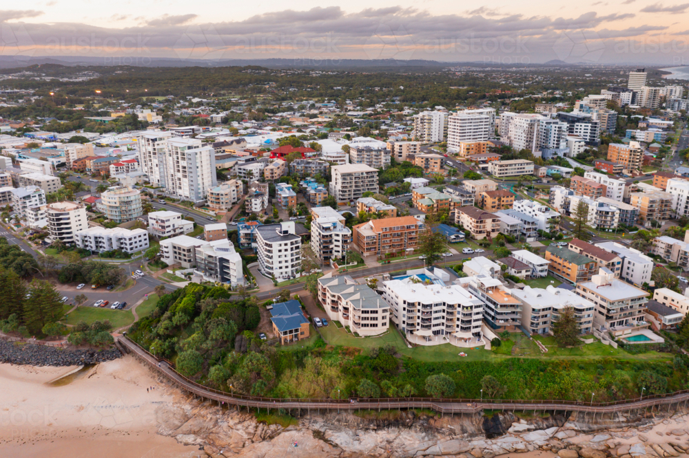 Image of Aerial view over a coastal city with highrise buildings at ...