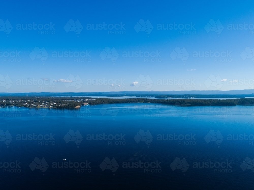 Aerial view over blue waters of Lake Macquarie towards Gwandalan and diamond drill point - Australian Stock Image