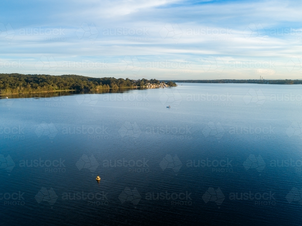 Aerial view over coastal lake water at sunset - Australian Stock Image