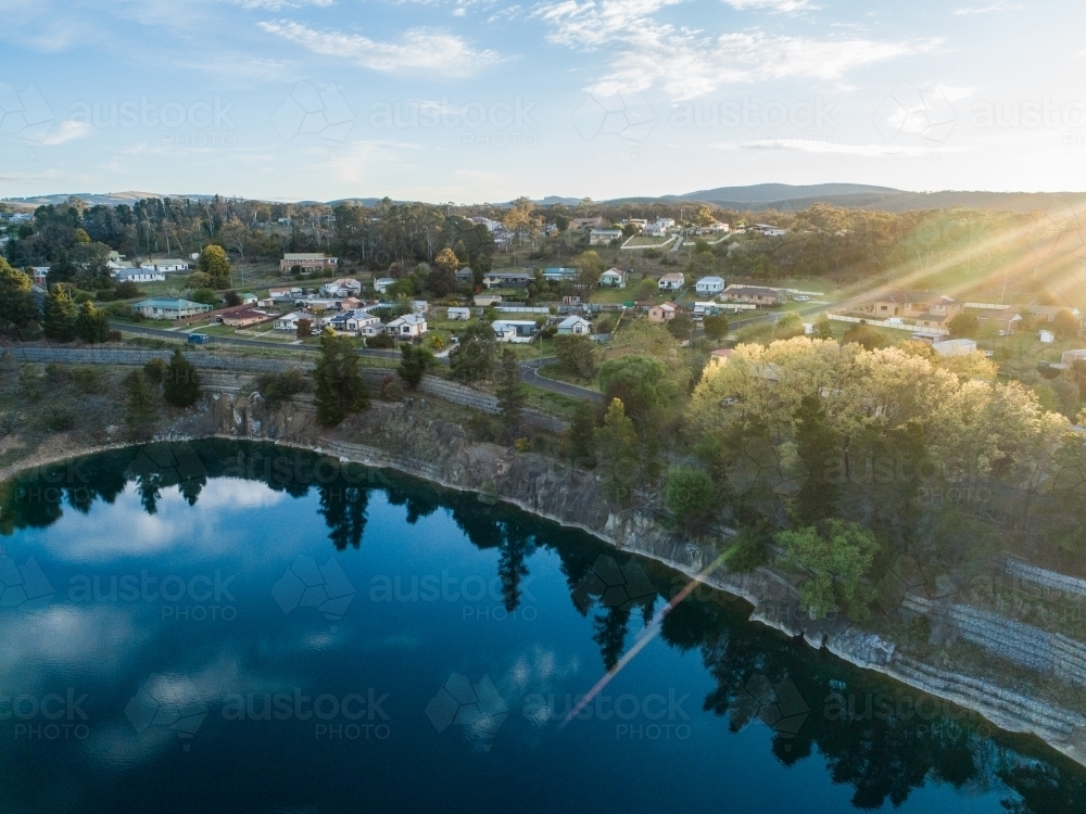 Aerial view over old quarry now a lake and spring trees in Portland - Australian Stock Image