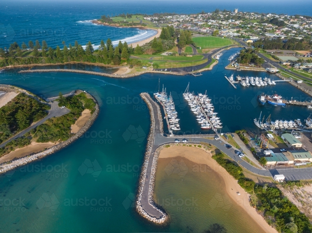 Image of Aerial view over rows of boats moored along a jetty in a ...