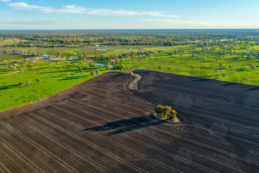 Aerial view showcasing cultivated farmland with striking patterns in the foreground - Australian Stock Image