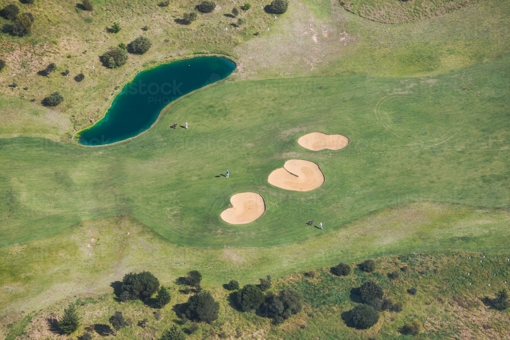 Aerila view over a lake and bunkers on a golf course - Australian Stock Image