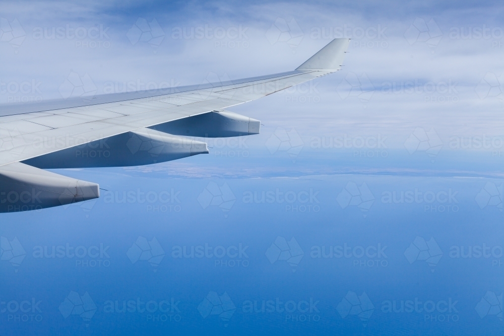 Aeroplane wing over ocean on Sydney to Perth flight - Australian Stock Image