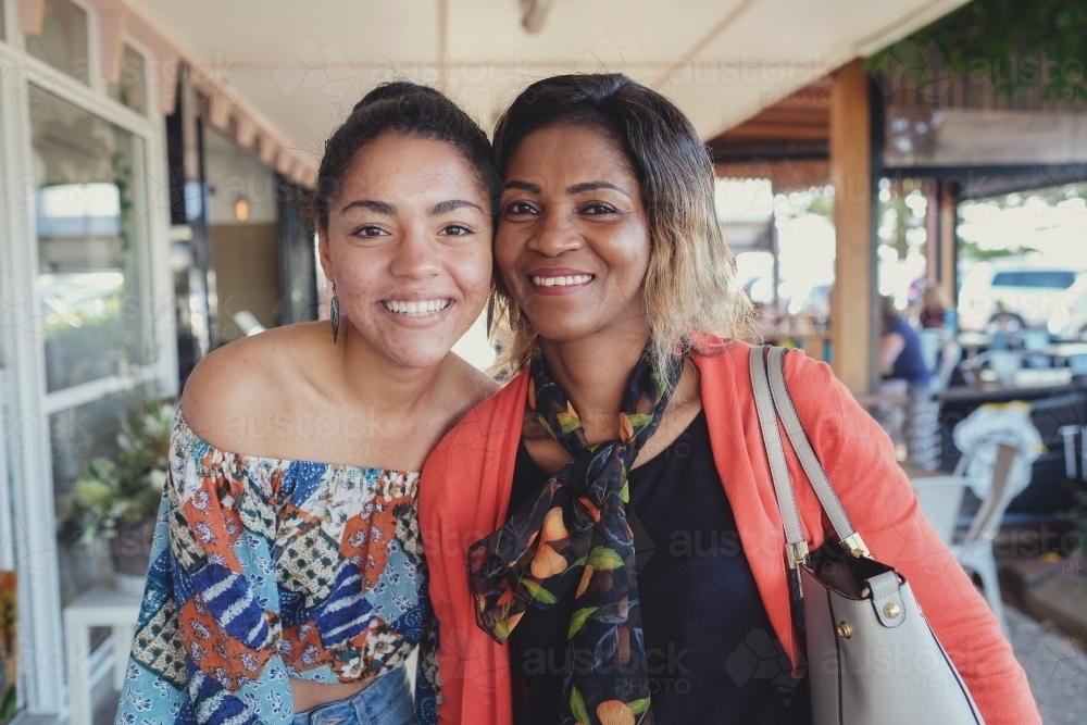 African mother and multicultural teen daughter - Australian Stock Image