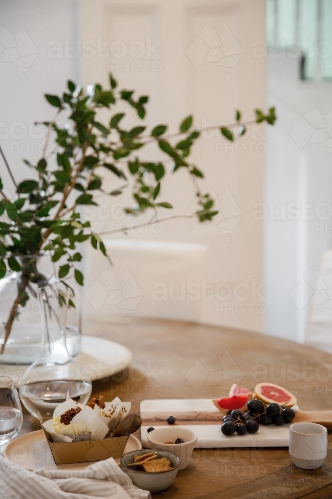 Afternoon tea with blueberry muffins and grapes and grapefruits - Australian Stock Image