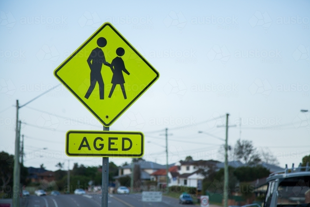 AGED yellow reflective sign beside busy road in Newcastle - Australian Stock Image