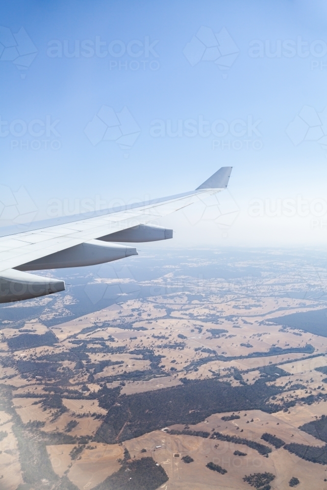 Air Plane wing and distant trees and farm land - Australian Stock Image