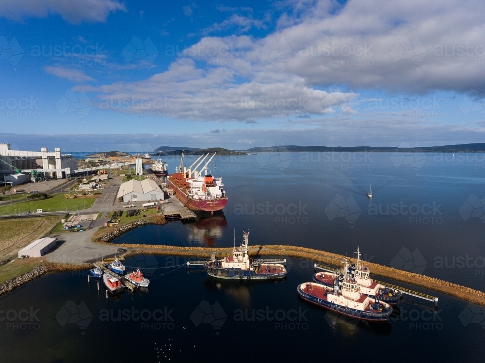 Albany port with ship and tugboats - Australian Stock Image