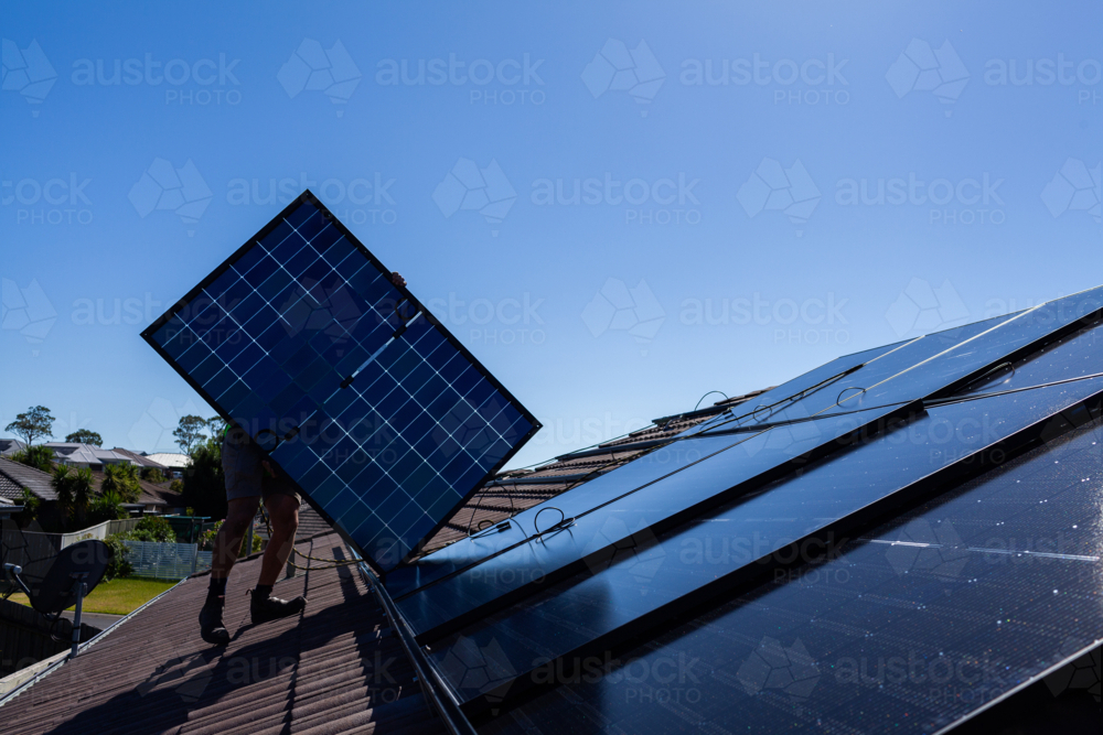 All Black bifacial solar panels on roof ready to be installed and connected to home power system - Australian Stock Image