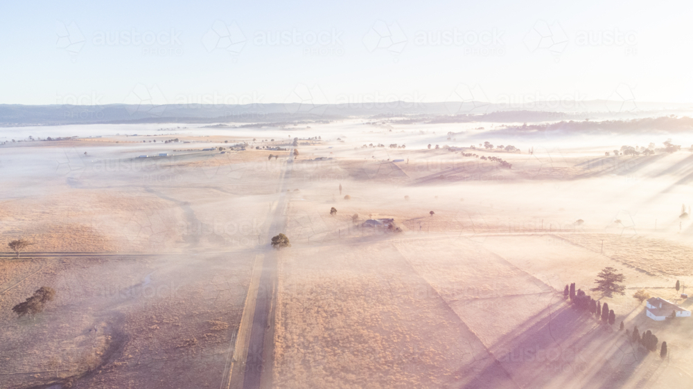 An aerial photo of a winter's scene with a mist and frosty fields - Australian Stock Image