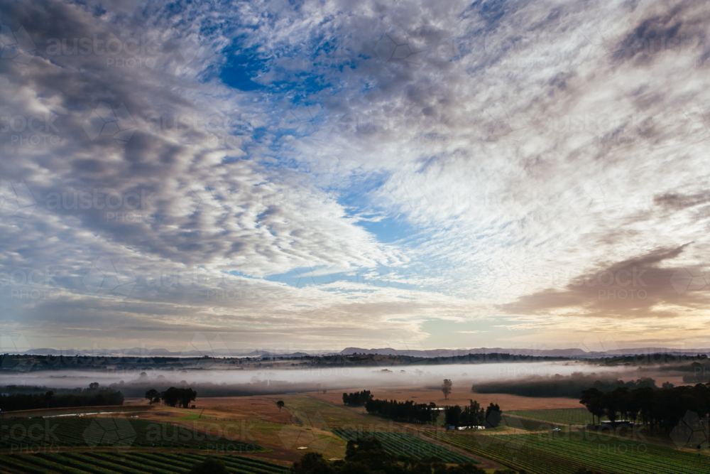 An aerial view across a valley at sunrise in the Hunter Valley, New South Wales, Australia - Australian Stock Image