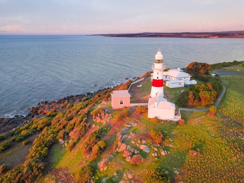 An aerial view of a lighthouse sitting on the top of a cliff - Australian Stock Image