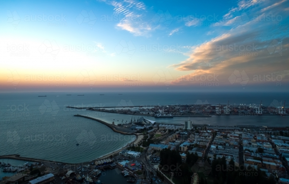 An aerial view of a port city at sunset - Australian Stock Image