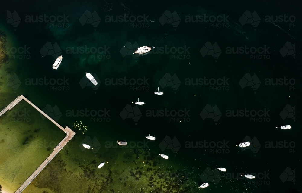An aerial view of boats moored near a river shore - Australian Stock Image