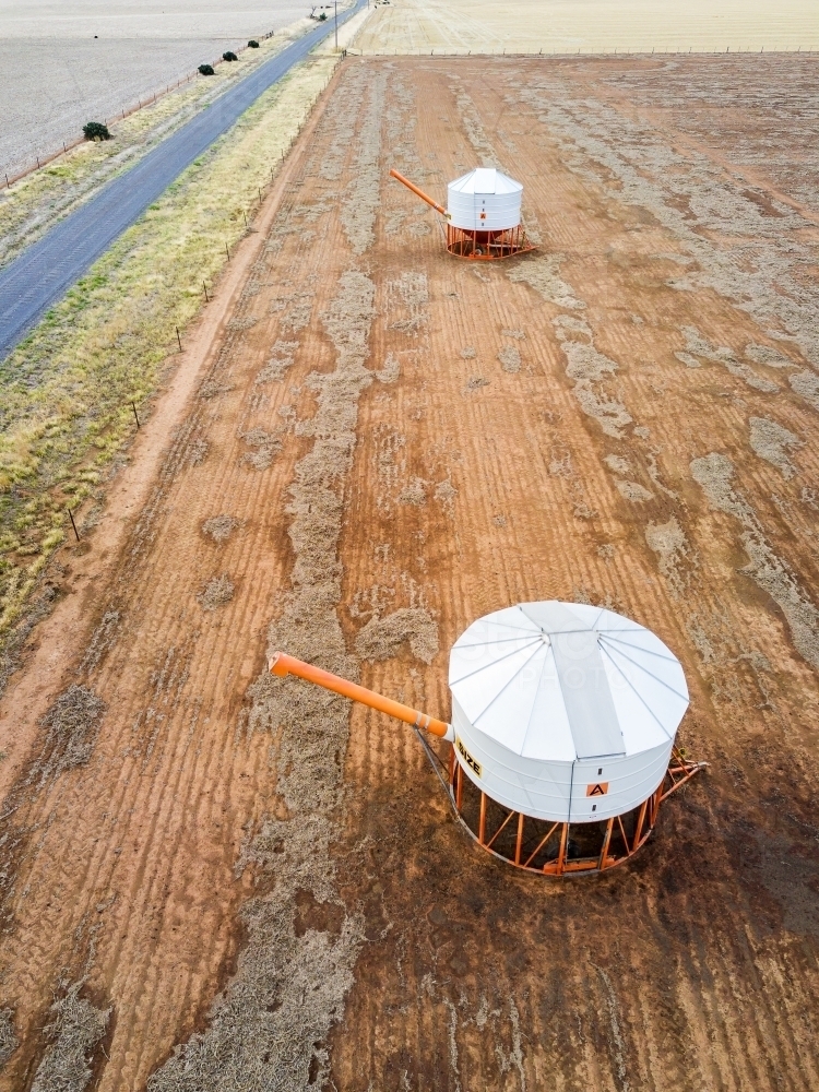 An aerial view of grain bins in a paddock - Australian Stock Image