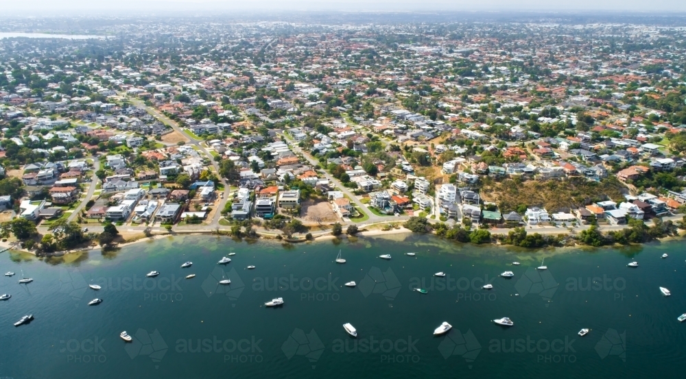 An aerial view of suburbia located near a river - Australian Stock Image