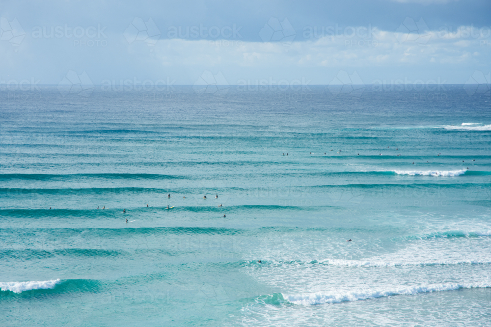 An aerial view of surfers waiting for a wave in the ocean - Australian Stock Image