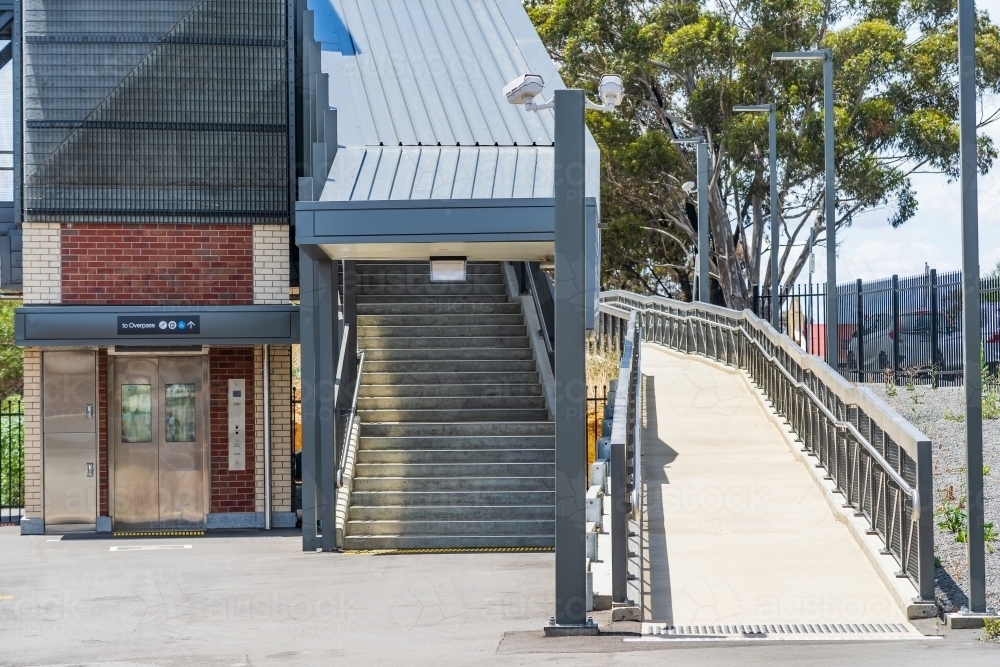 An elevator, stairs and an access ramp at a regional railway station - Australian Stock Image