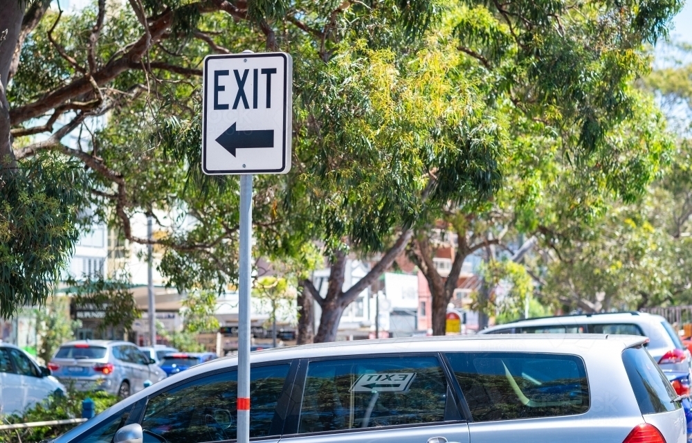 an exit sign at an outdoor parking lot - Australian Stock Image