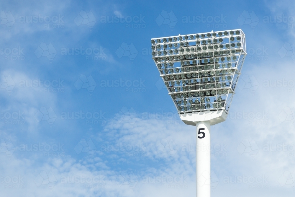 Image of An MCG lighting tower set against a blue sky Austockphoto