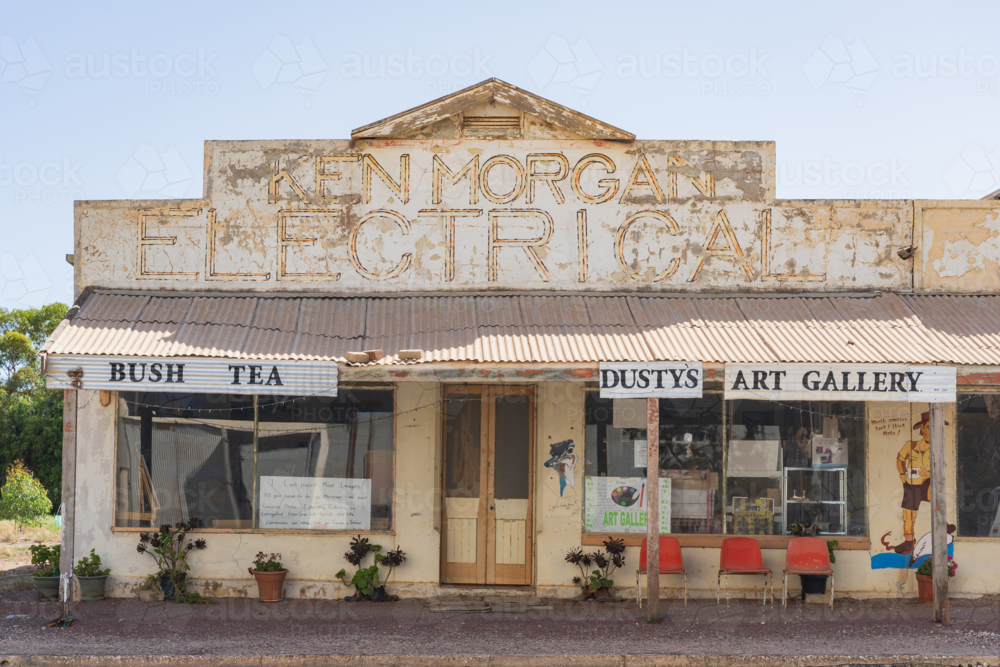 Image of An old run down electrical store with seta under a wide ...