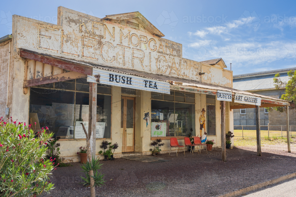 Image of An old run down electrical store with seta under a wide ...