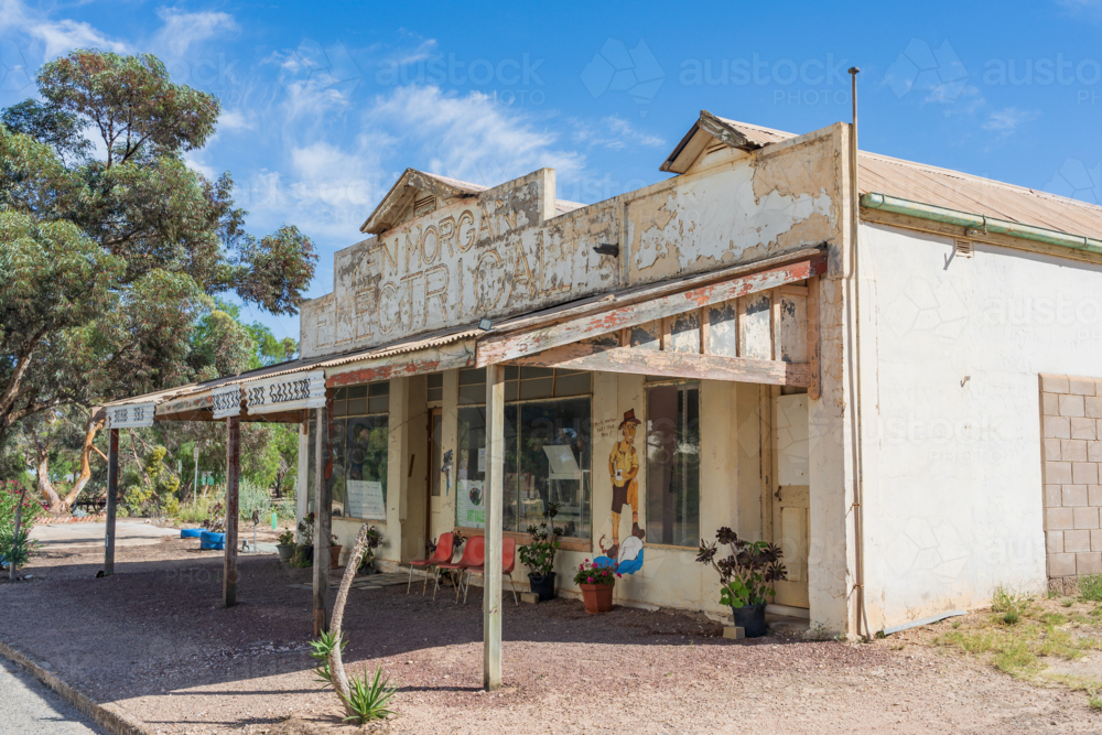 Image of An old run down electrical store with seta under a wide ...