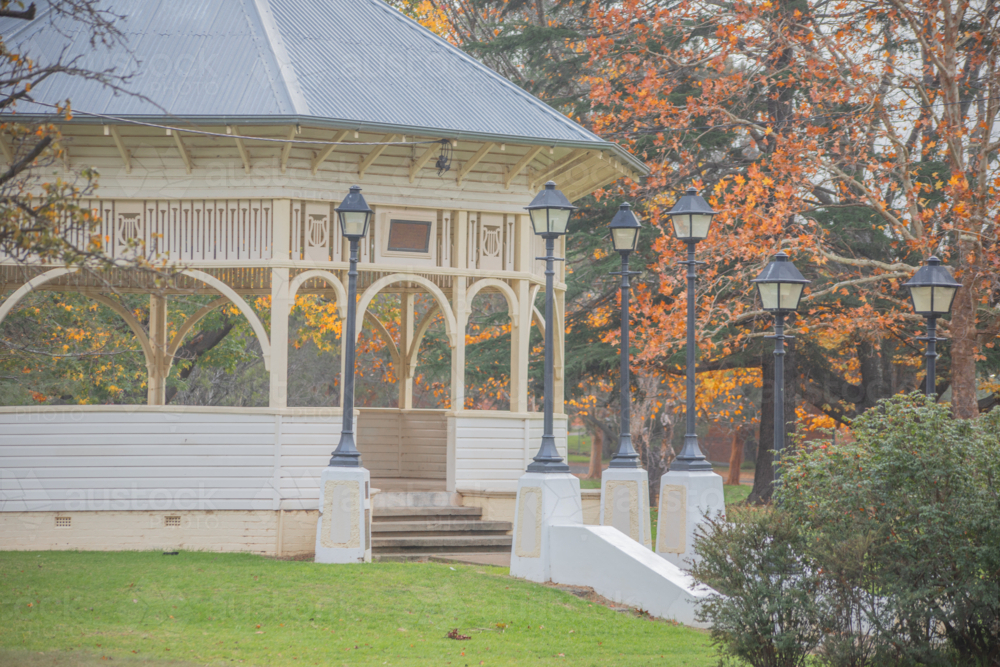 An old small town rotunda in a park surrounded by golden autumn leaves - Australian Stock Image
