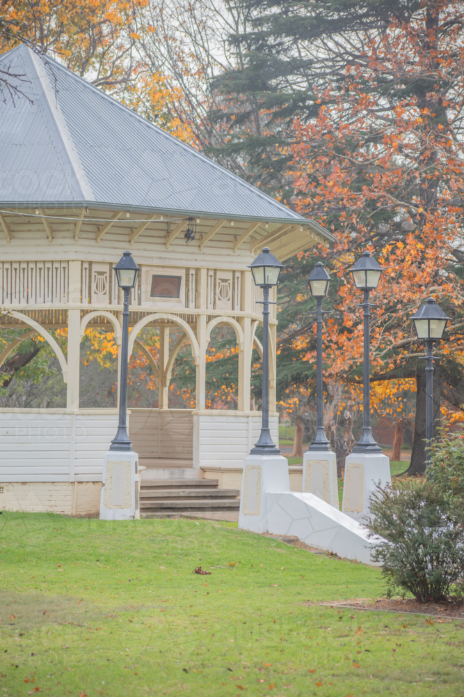 An old small town rotunda in a park surrounded by golden autumn leaves - Australian Stock Image