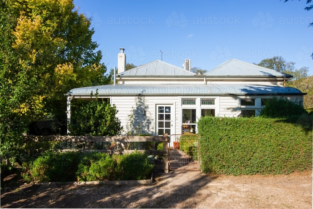 An old white house with rustic gate - Australian Stock Image