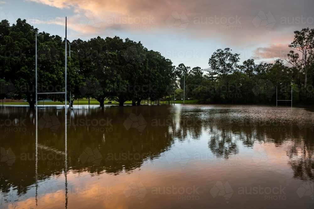 An open field flooded with water mirroring the sky. - Australian Stock Image