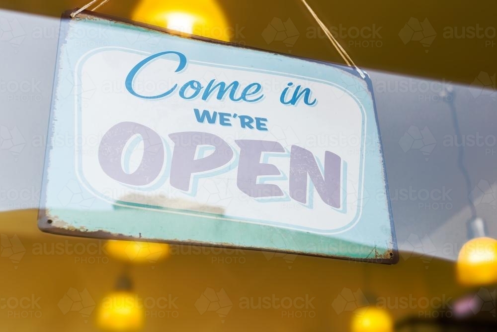 An open sign hanging in a window - Australian Stock Image
