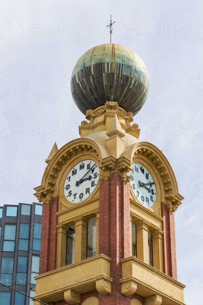 An ornate historic clock tower with a large copper dome on top. - Australian Stock Image