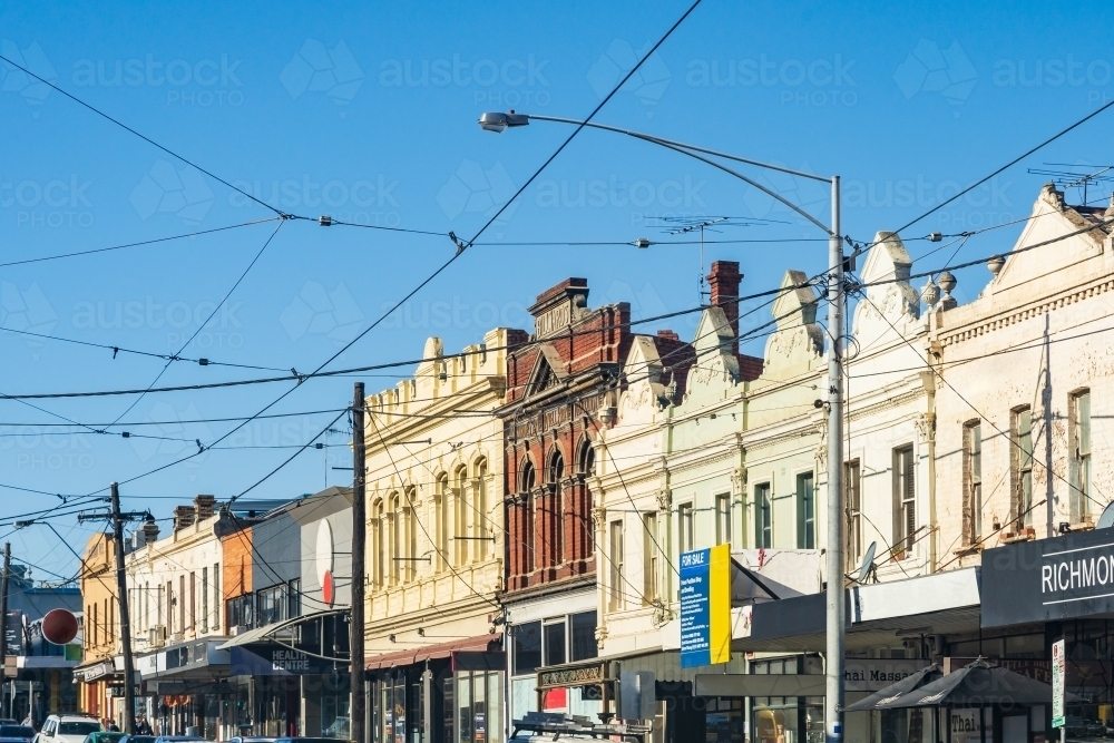 An urban streetscape with old fashioned facades and overhead tram cables - Australian Stock Image