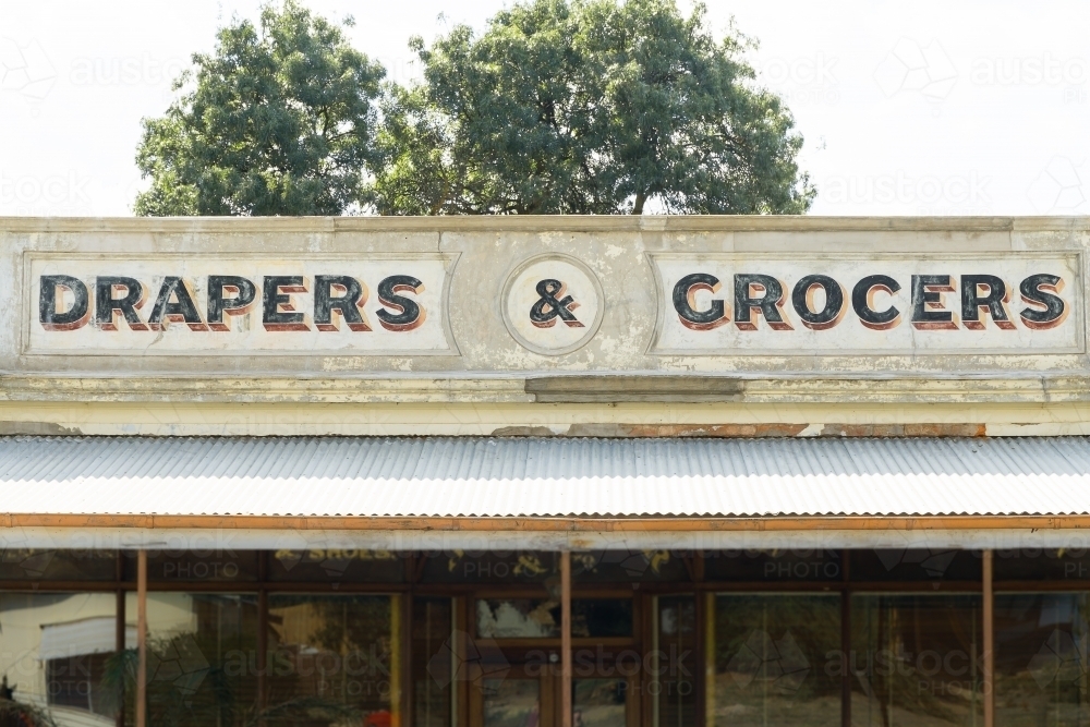 An weathered painted sign on the the facade of an old shopfront - Australian Stock Image